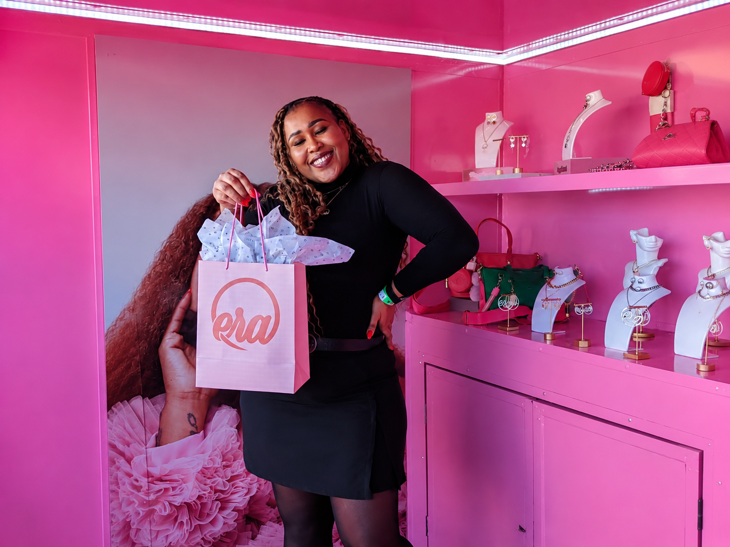 Guest inside a hot-pink Era pop-up retail activation